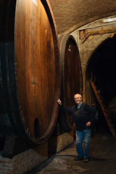 Winemaker Mauro Mascarello at Giuseppe Mascarello winery in Barolo Piedmont Italy with the historic barrels his grandfather had custom made for the winery