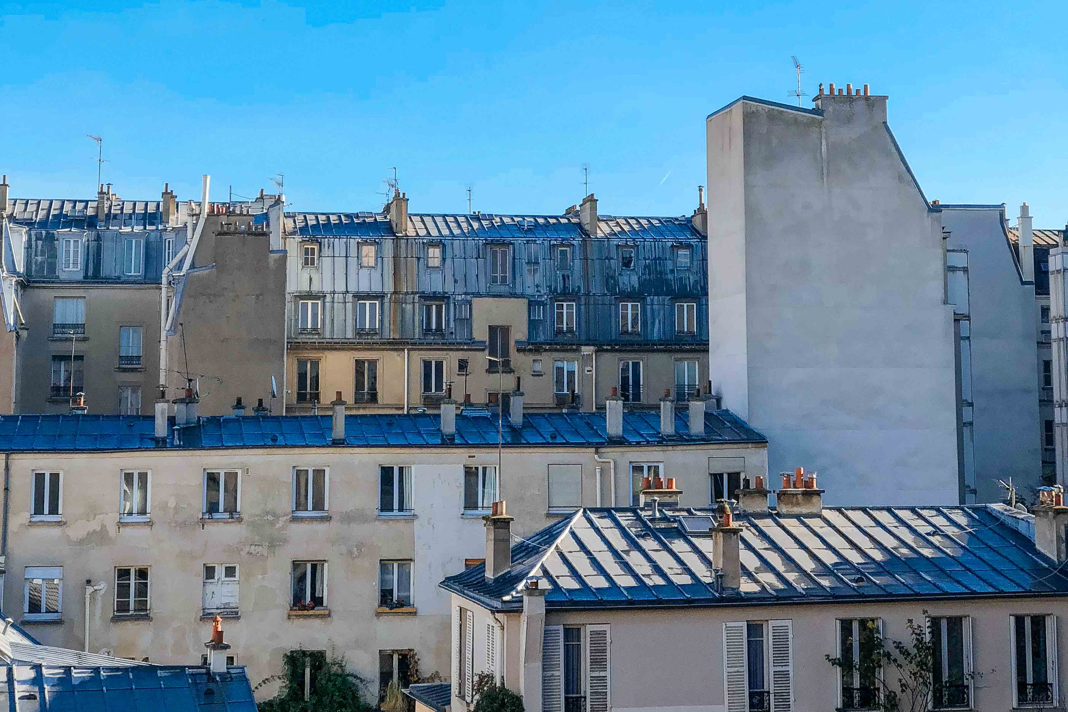 Eat well in Paris and get recommendations here while looking at the Paris rooftops in - photo by Kate Leahy