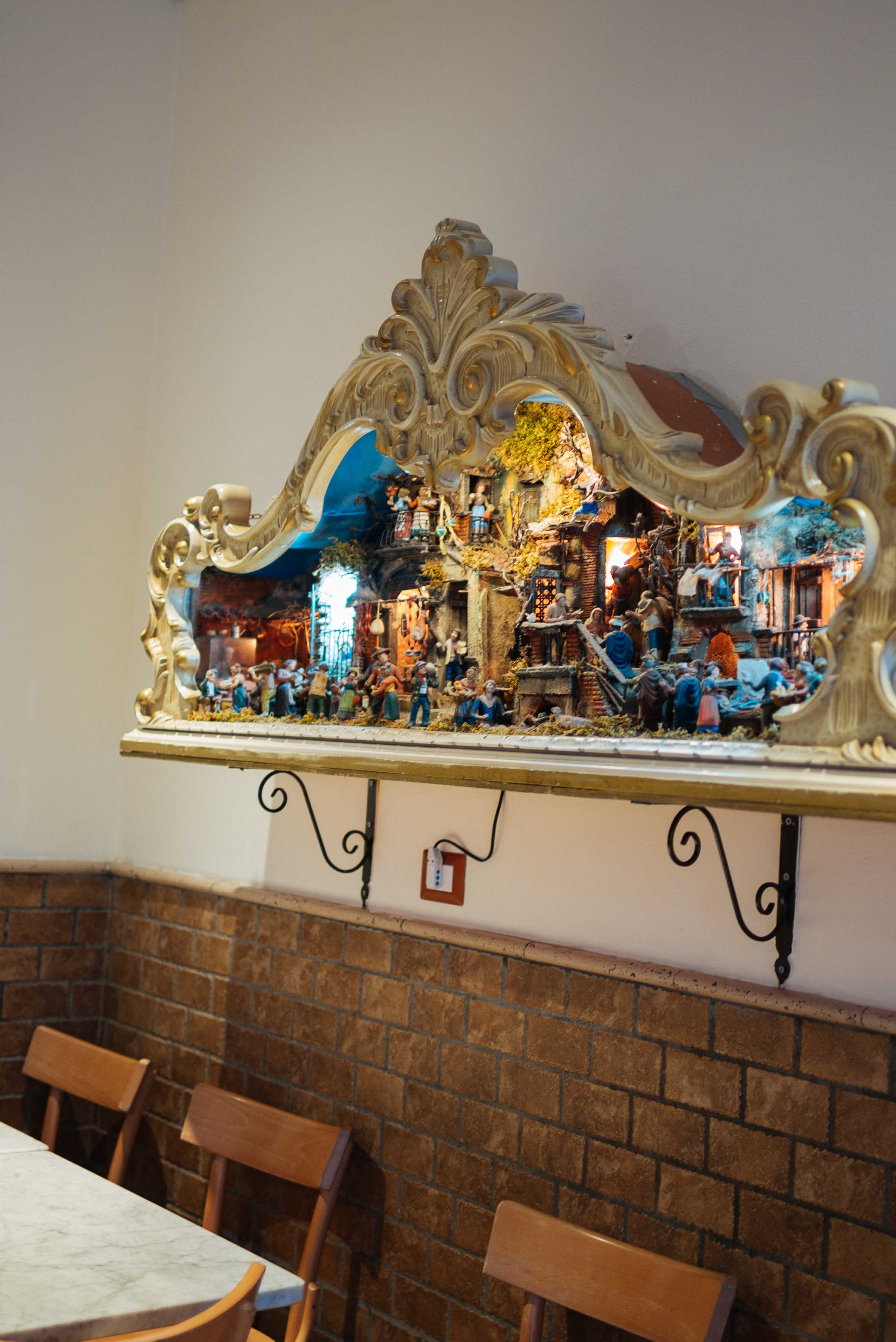 Go to this pizzeria in Napoli for the best pizza in Italy. Simple restaurant decor including this nativity scene. #pizza #nativity #christmas #italy