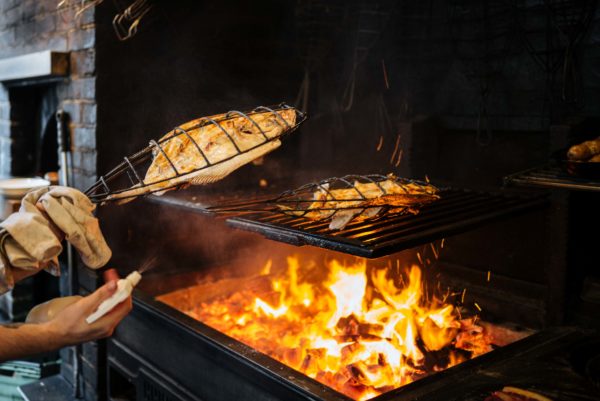 Brat restaurant roasting whole turbot over an open fire in London