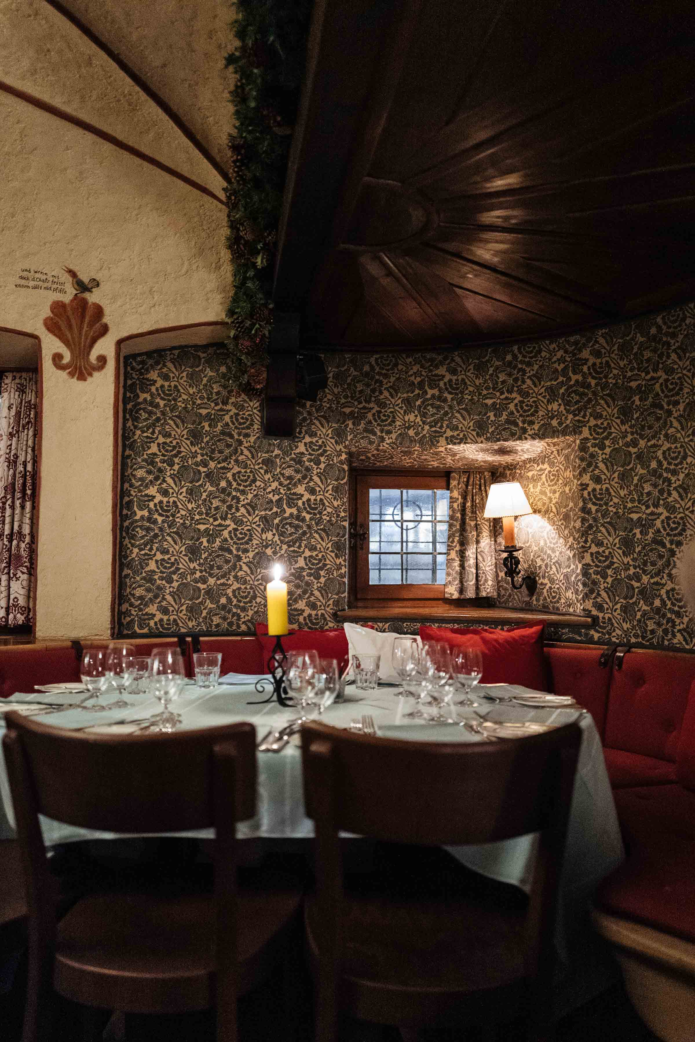 Have dinner in the dining room at this Klosters Hotel or have a set table in the bar downstairs at the historic chesa grischuna of Klosters at night near Davos | The Taste Edit #travel #switzerland #swiss #bar #food #tablesetting