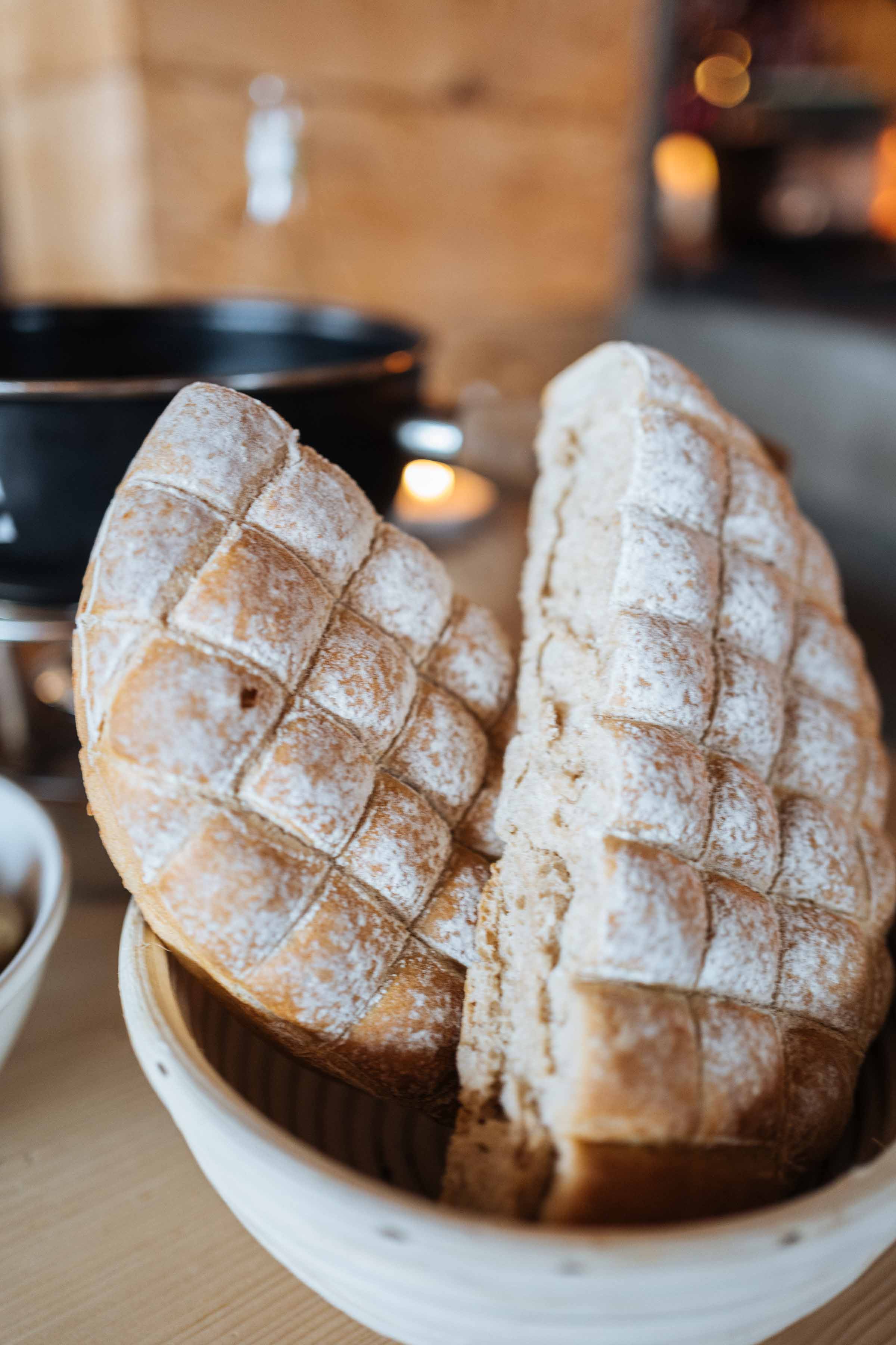 Fondue for two at Klosters restaurant Gasthaus Hohwald is served with bread that is pre cut so it's easy to pull apart when having fondue.