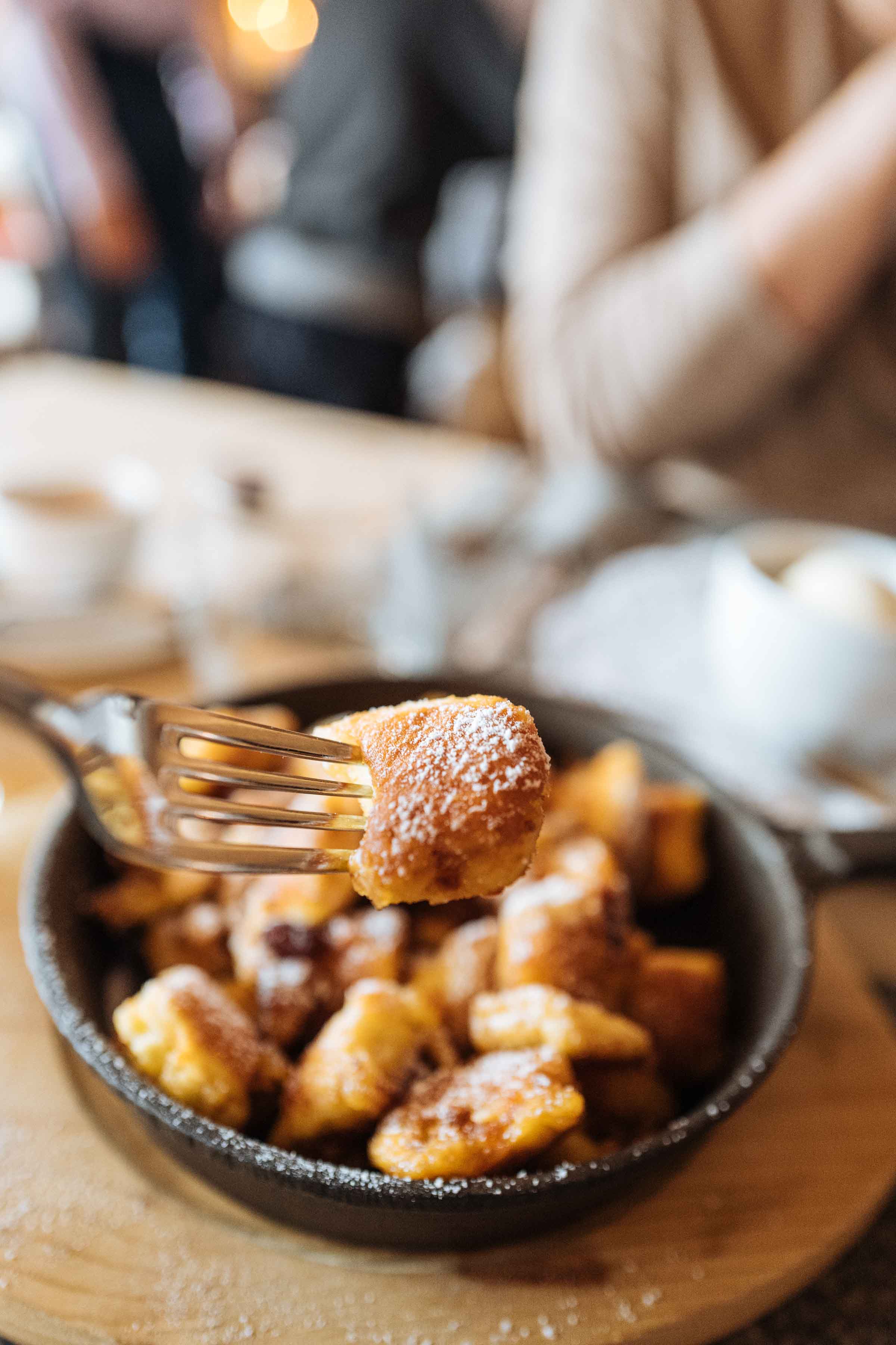 Kaiserschmarrn or Kaiserschmarren (Emperor's Mess) is a scrabbled pancake you’ll want to warm up with after dinner in this Swiss town. Know where to go and which restaurant to get it at with our guide to Klosters. | thetasteedit.com #travel #switzerland #winter #food #dessert