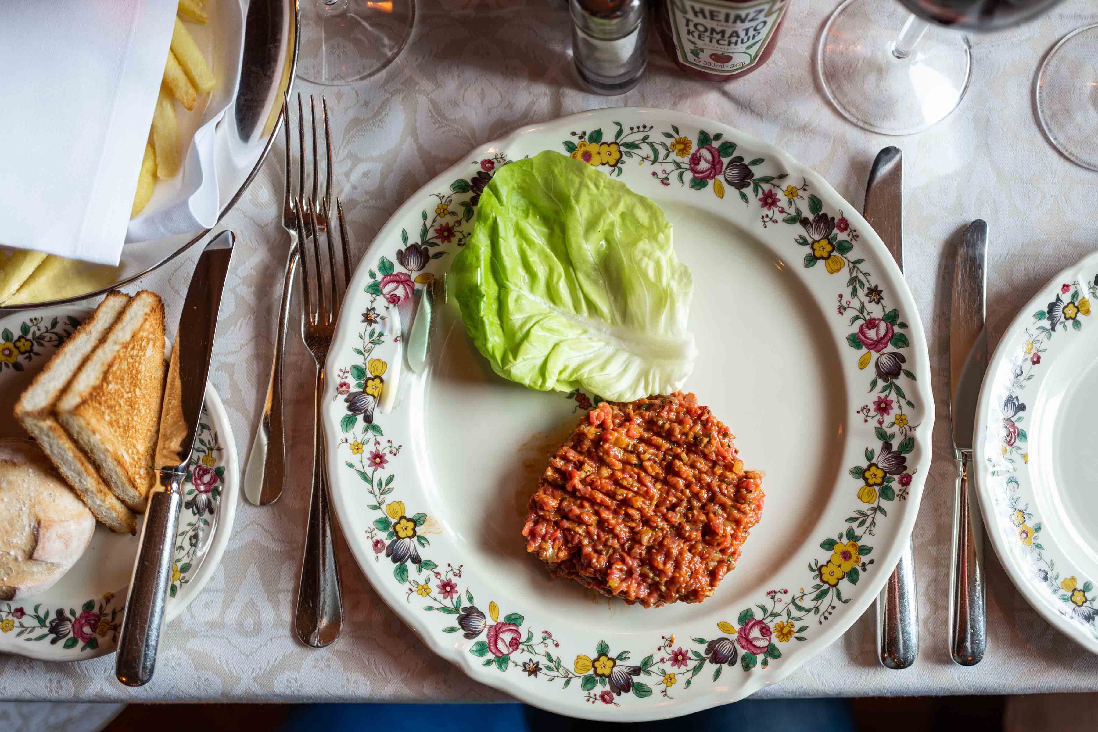 steak tartar is served with toast and a side of fries at Chesa Veglia St Moritz restaurant | thetasteedit.com #travel #switzerland #stmoritz