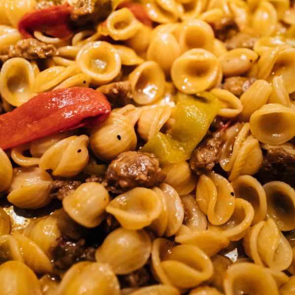 Make this easy Italian Sausage and Pepper Orecchiette Pasta recipe. It's a quick dinner made with orecchiette pasta, garlic, onions, and tomato paste from TheTasteEdit.com #recipe #sausage #pasta