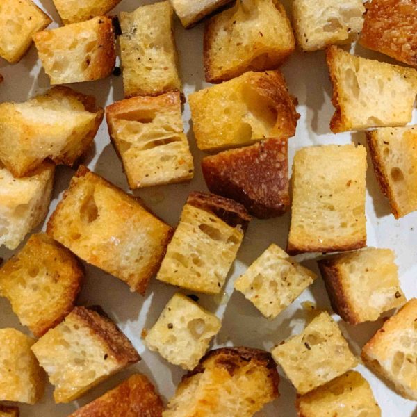 Use your leftover bread to make the best oven-roasted homemade croutons to add to your soup, salad, or even for a snack | thetasteedit.com #recipe #bread #salad