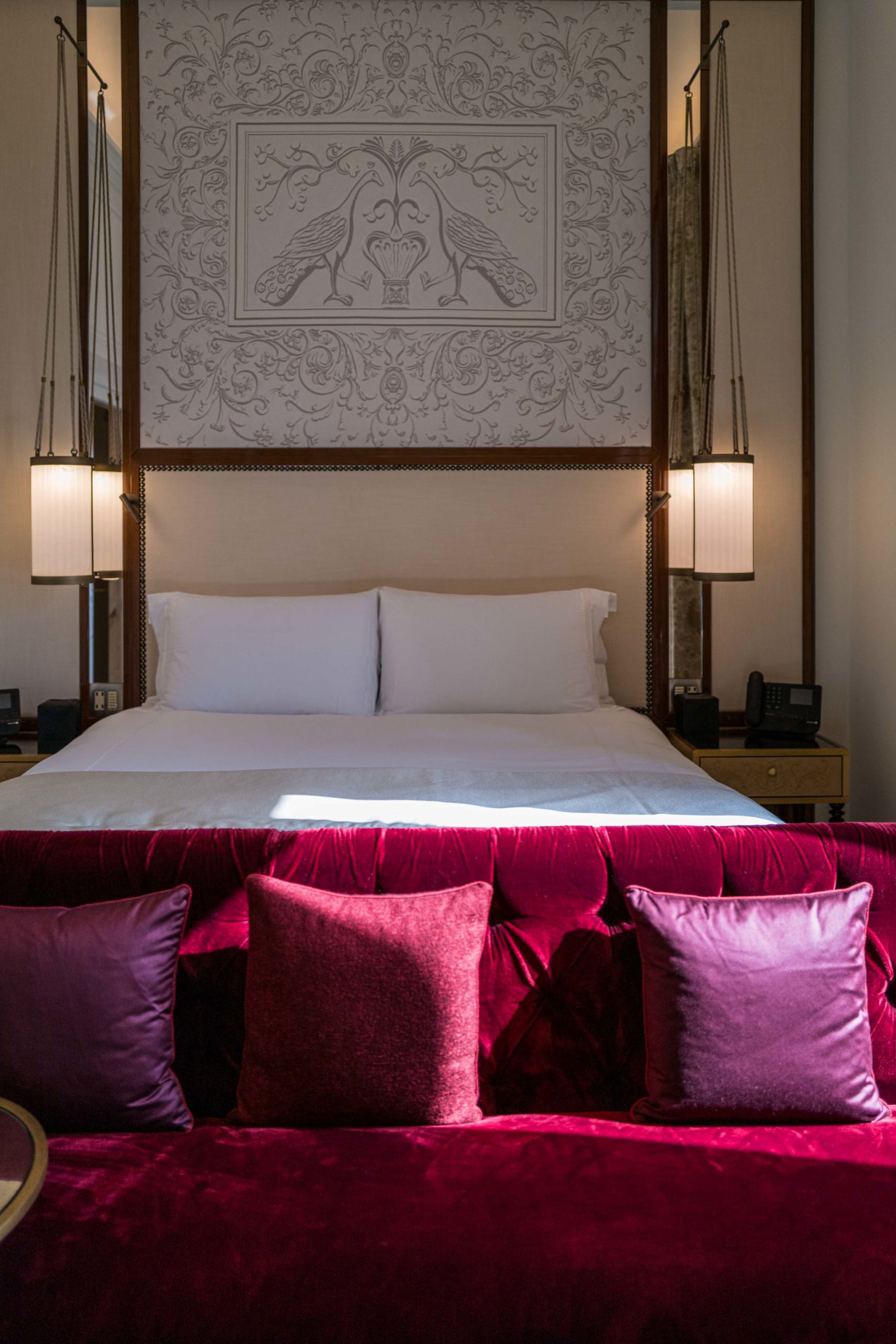 Beautiful red fabric and plush chairs are in La Dolce Vita corner suite at the Hotel Eden Rome for a unique experience, The Taste Edit #hotel #rome #italy #decor