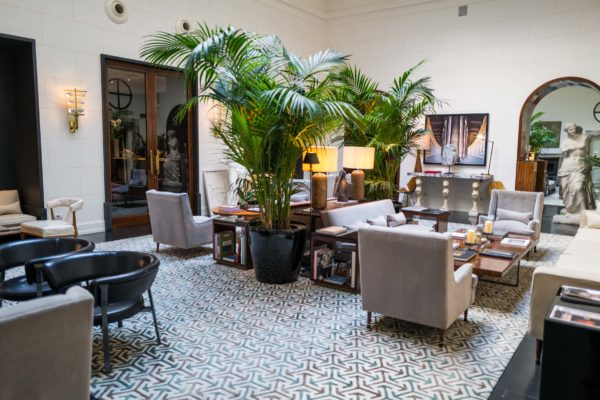 Enjoy the open atrium surrounded by life size marble statues, palm trees, and plush furniture at the JK Place Roma hotel in Rome, The Taste Edit #hotel #rome #travel #decor