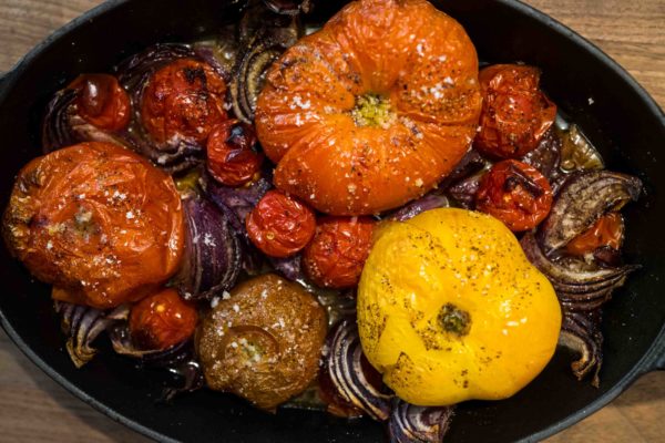 Bake tomatoes for a healthy vegetarian dinner with couscous and harissa recipe from Nigel Slater