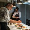 Chef decorating colorful gourmet desserts in a modern kitchen.