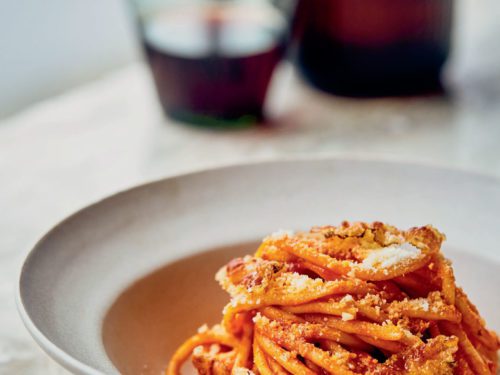 Homemade Amatriciana - Italian pasta based on guanciale (cured pork cheek),  pecorino cheese, tomato, white wine, olive oil. Cucina romana tradizionale.  Original recipe fixed by Comune di Amatrice. Stock Photo