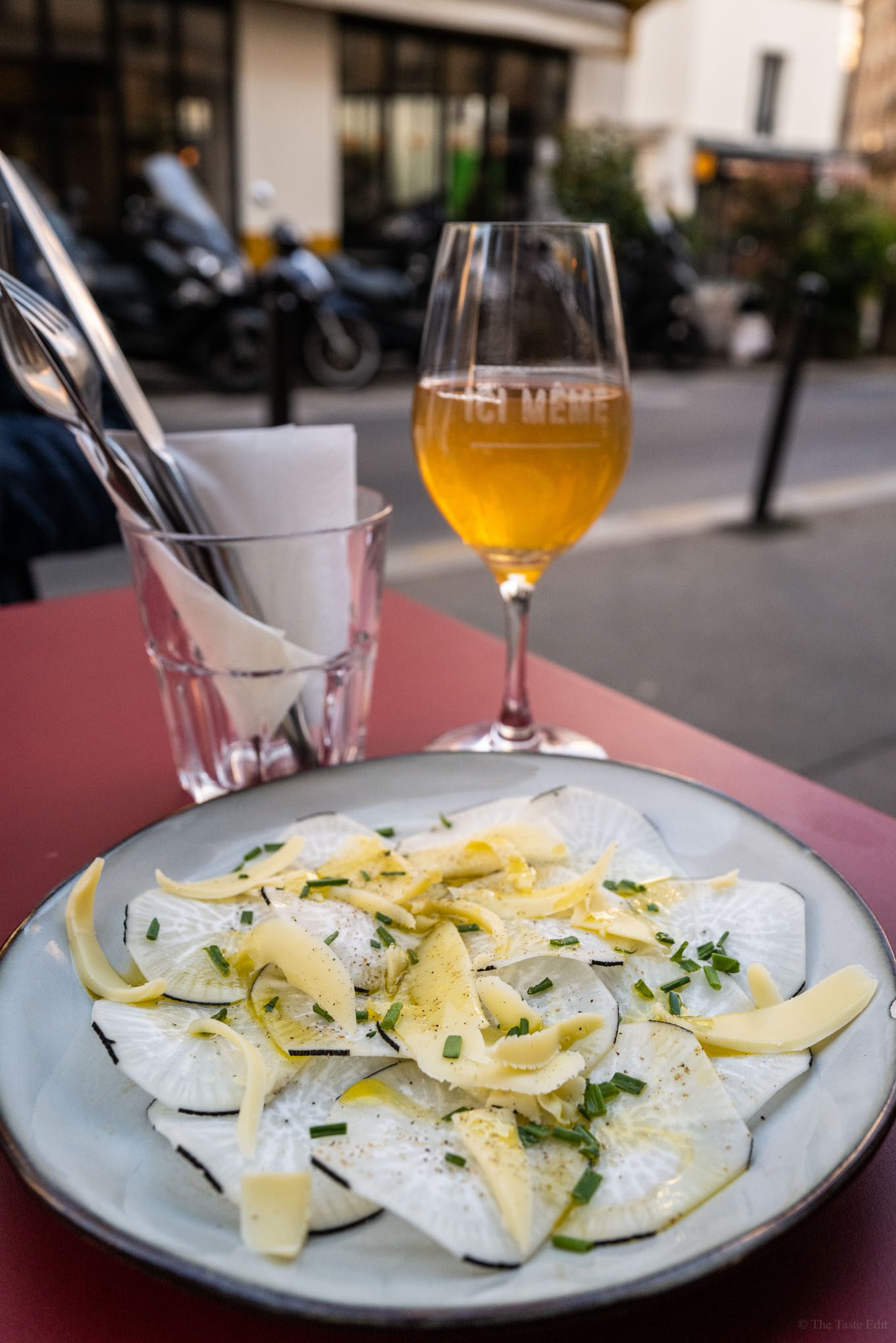 A plate of radishes and cheese with wine at Paris ICI mem wine bar and cave manger Paris. Know what a Cave a Manger in Paris is? This is important if you want to go to one of the most up and coming wine bars in Paris. Use our Paris Black Book to find out about the rules and where the best wine bars are in Paris. #wine #Paris #restaurant