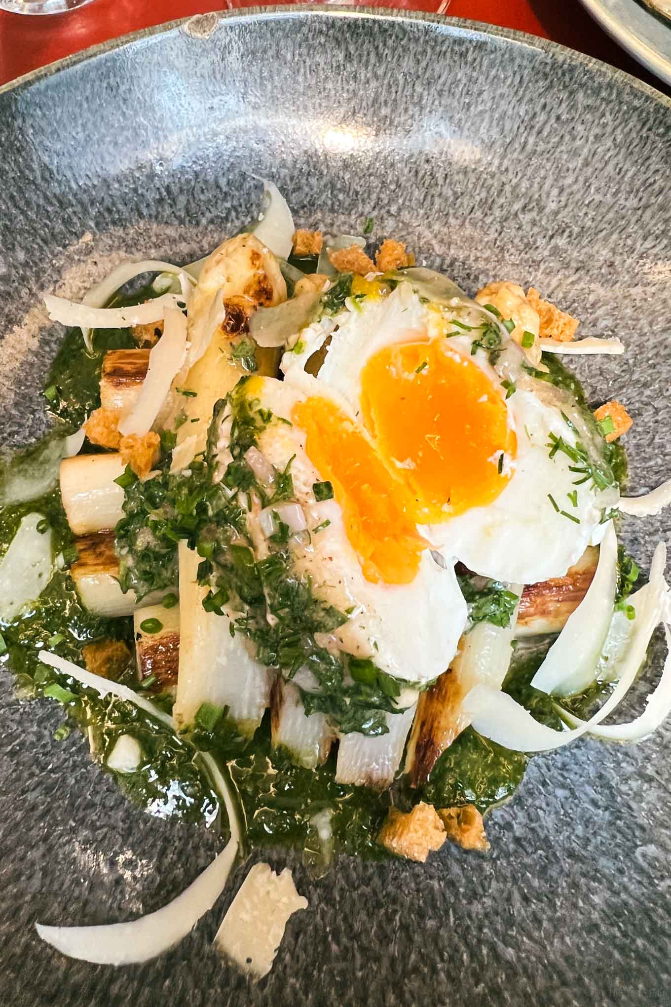 Seasonal recipes like this white asparagus and soft boil egg at juveniles one of the best restaurants in Paris
