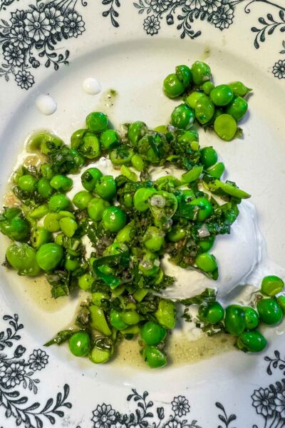 Make an easy pea and burrata salad with minced cilantro and mint served with crusty bread for lunch or a vegetarian dinner