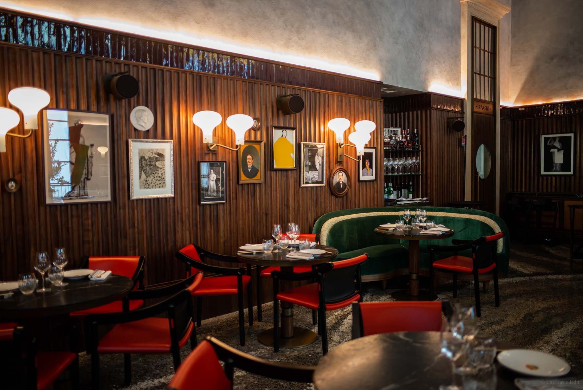 Luxurious leather seating at Beefbar Milan restaurant, with tall chairs arranged around a circular tables in the center of the dining room