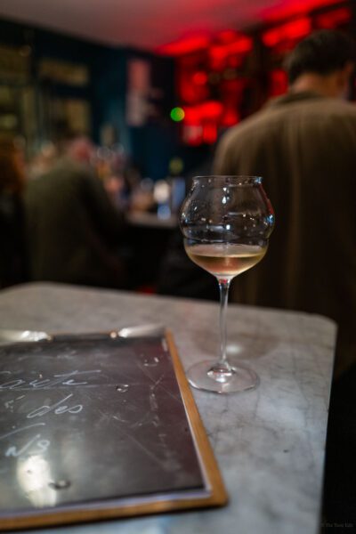 Wine in wine glass with wine menu on the counter in a natural wine bar GCD Montmarte in Paris France