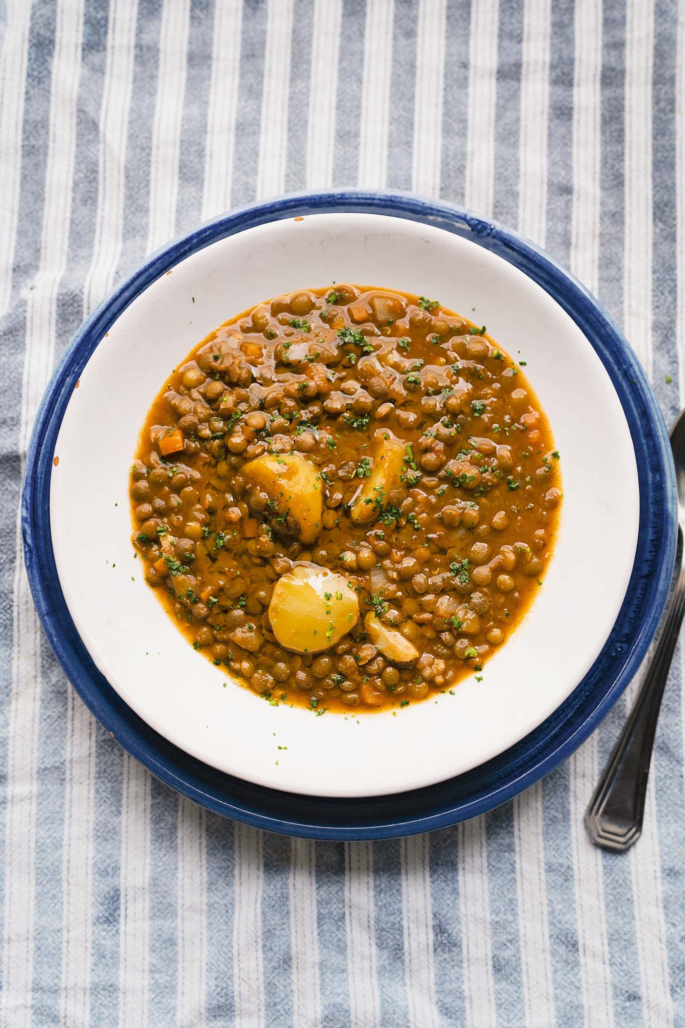 Hearty sicilan lentil soup served on a stripped towel