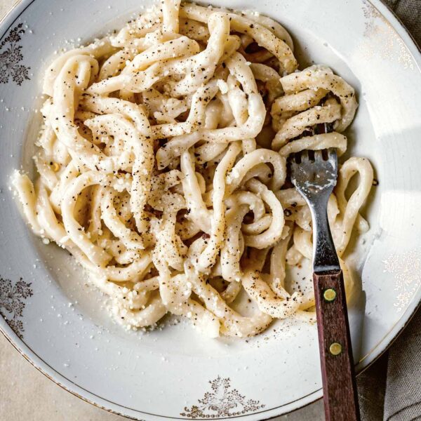 Cacio e pepe, an iconic pasta dish with a creamy Pecorino Romano and black pepper sauce