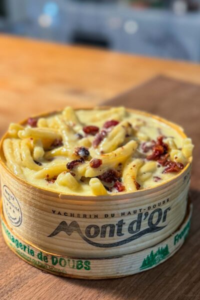 mont d'or cheese mixed with bacon and pasta for an easy dinner