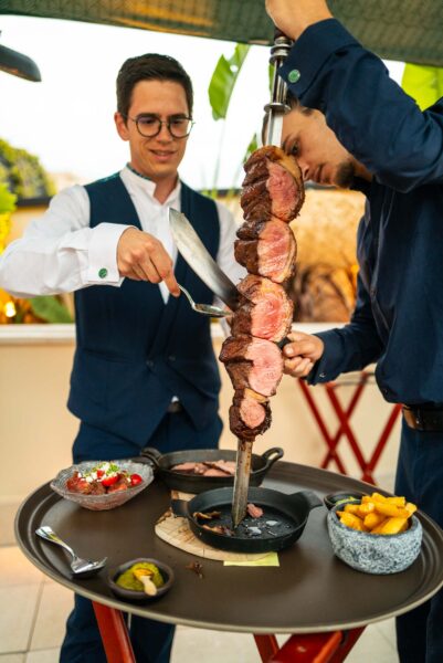 sliced beef with knife on spit at Amazonico Restaurant in Monte-Carlo Monaco