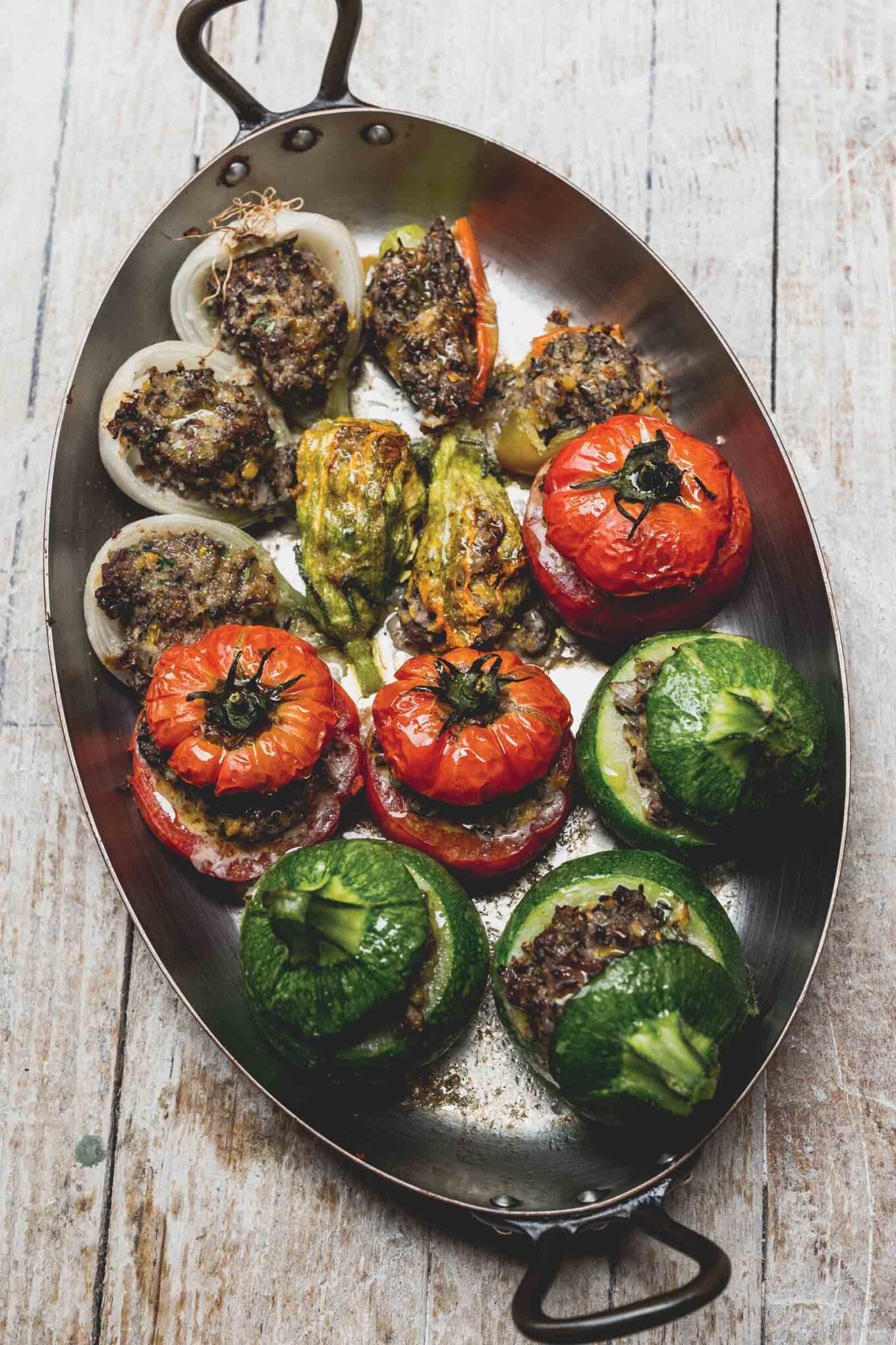 Petit farcis niçois from Nice a summer dish made with tomatoes, onions, and zucchini in an oval pan