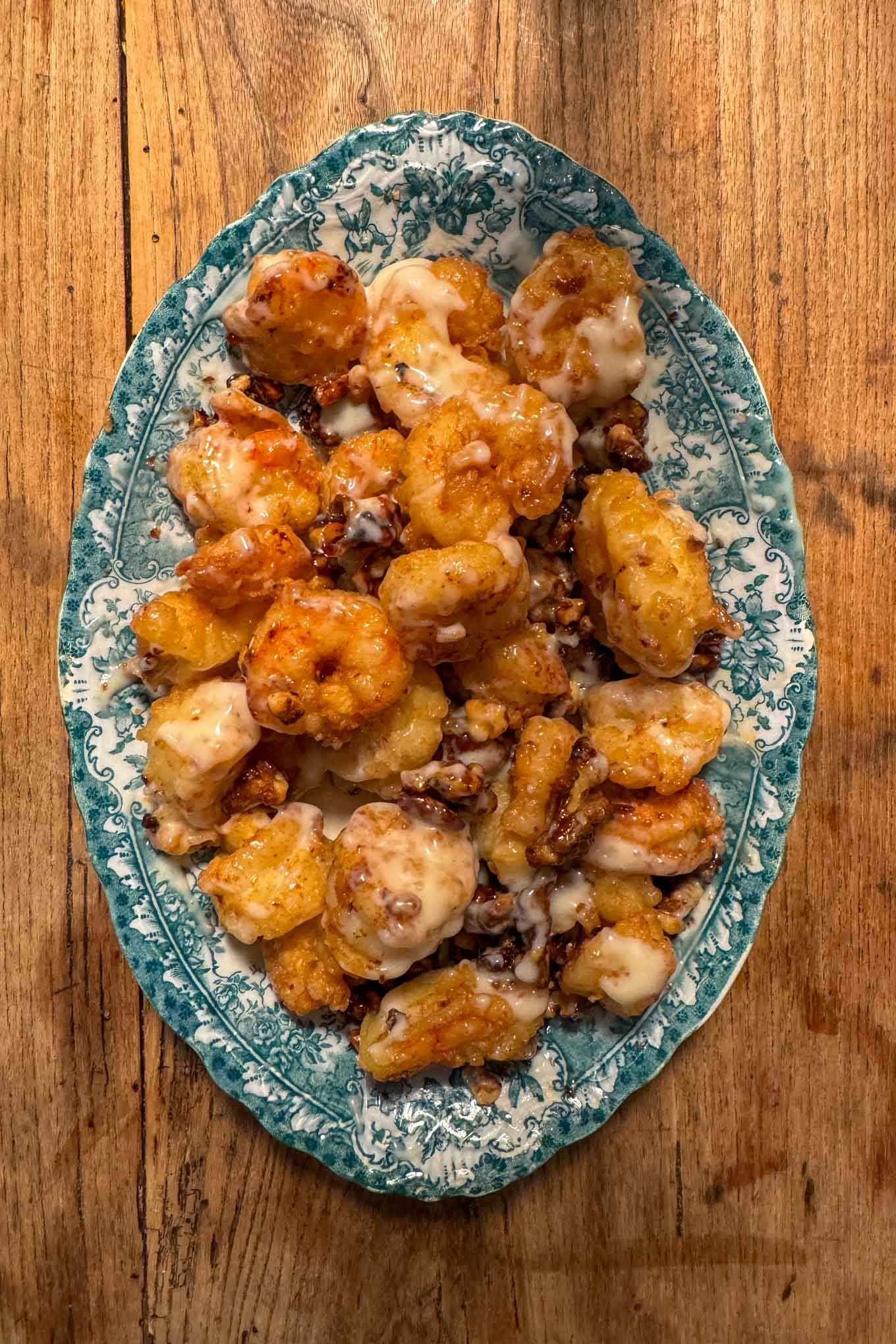 Easy honey walnut shrimp Chinese food recipe with crispy shrimp and sweet sauce on vintage blue plate
