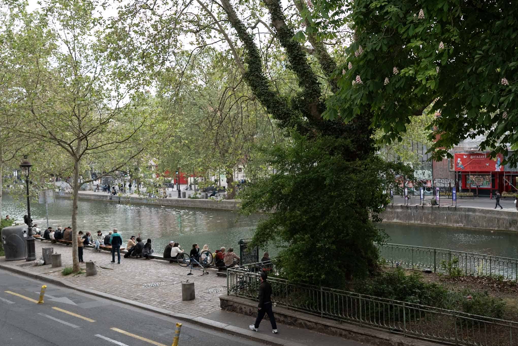 Natural wine along the River Thames in London, with people relaxing by the water.