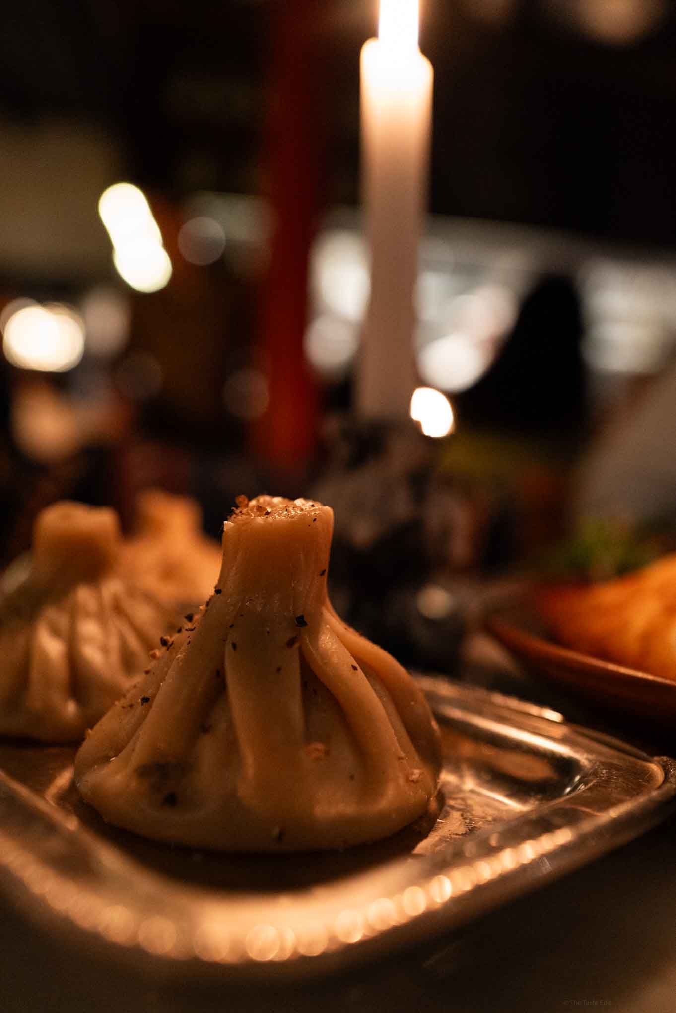 Georgian soup dumplings at Daka Daka in London with a candlelit ambiance, perfect for fine dining and special occasions.