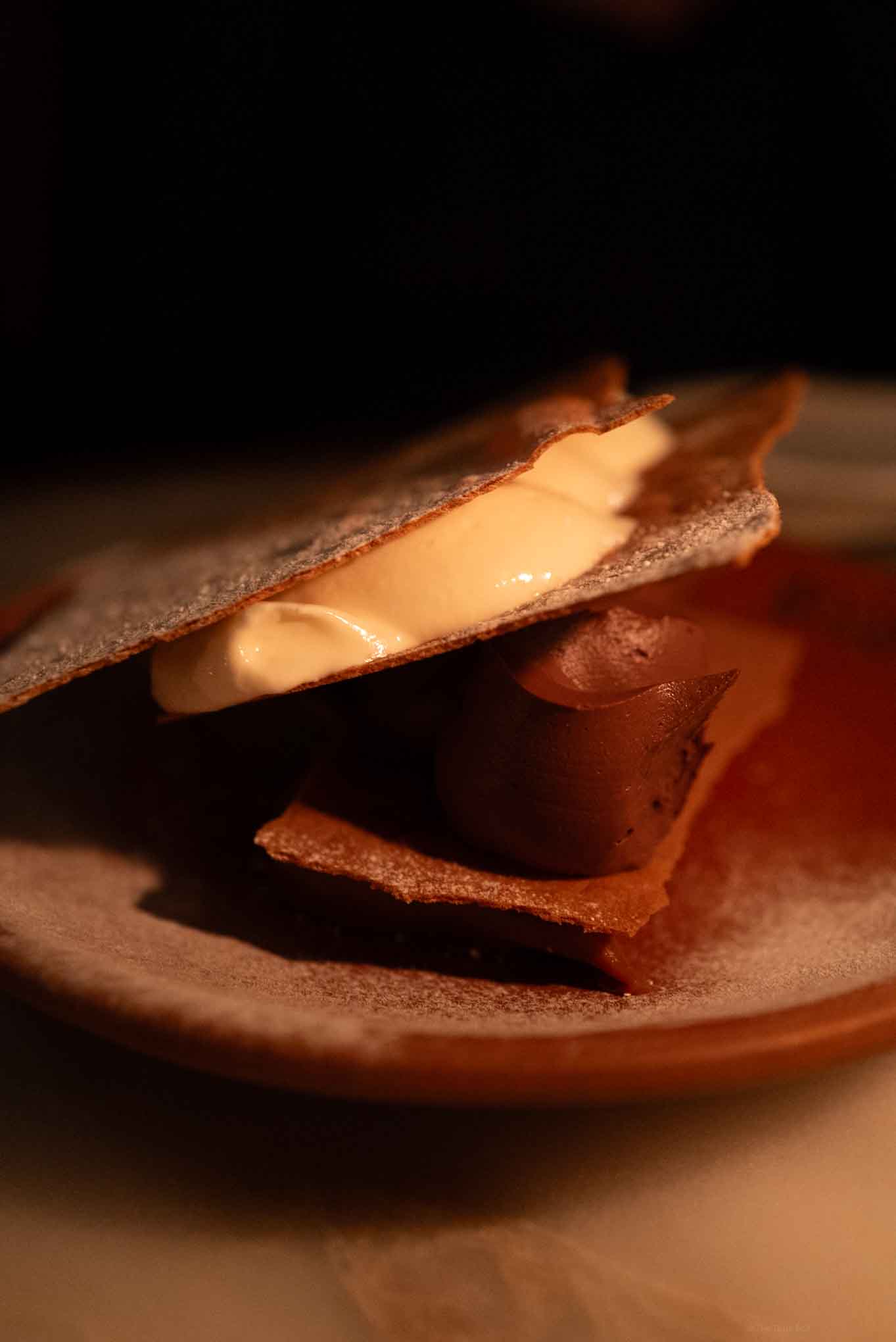 Chocolate and caramel layered dessert with crispy wafers and smooth filling.