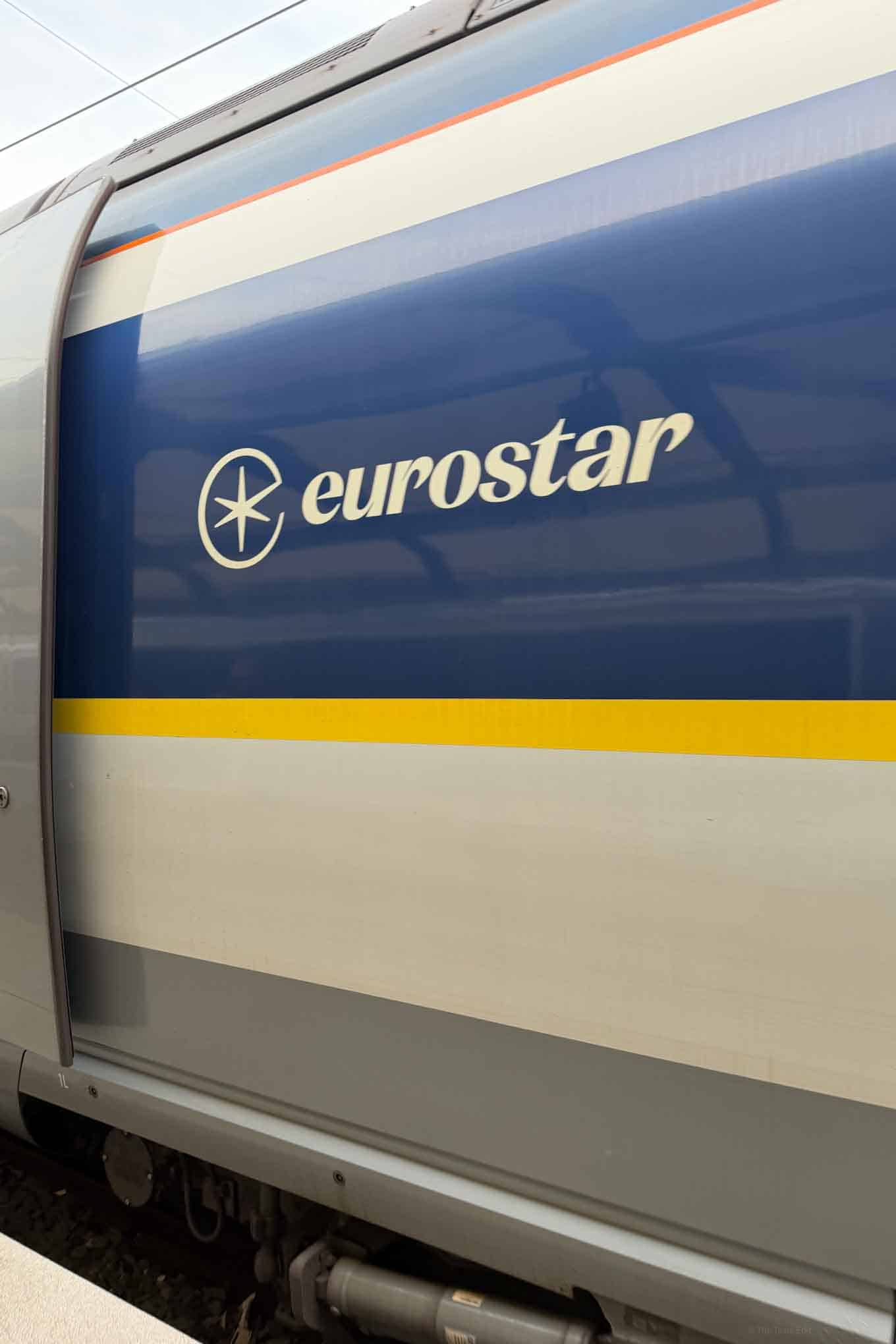 Eurostar train exterior with Eurostar logo and sleek blue, white, and yellow design.