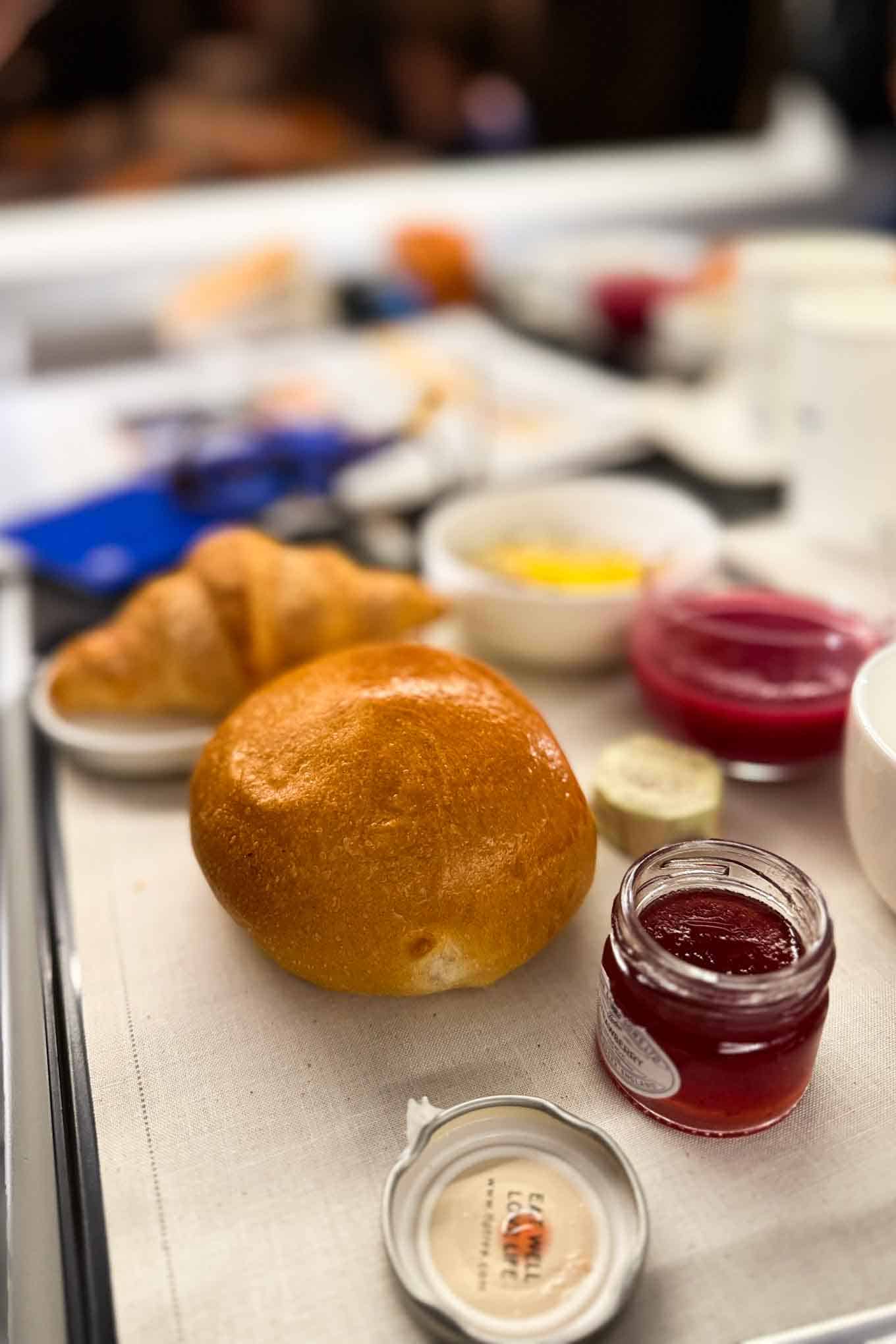 Freshly baked bread and jams for natural wine tasting in a cozy setting.
