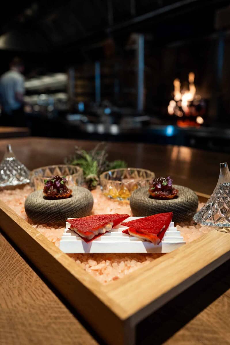 Elegant gourmet appetizer platter with colorful canapés and decorative garnishes for upscale dining.