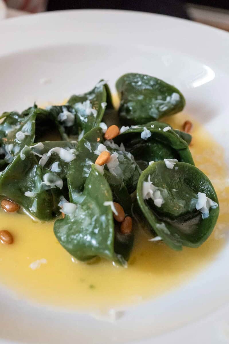 Delicious nettle spinach ravioli topped with white cheese served with a light butter.