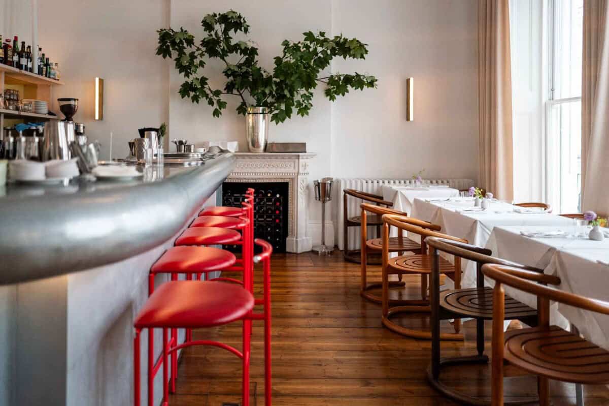 Elegant restaurant interior with stylish seating and natural light.