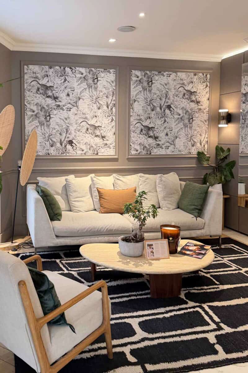 Stylish living room featuring abstract black-and-white wall art and a comfortable white sofa with co.