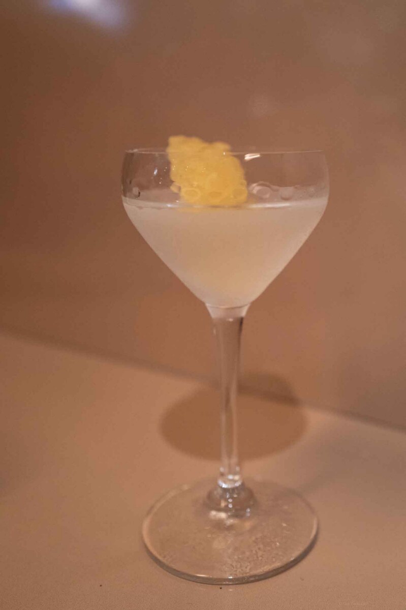 Lemon Drop cocktail garnished with lemon peel in a martini glass.